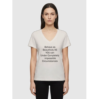Woman wearing off white V-neck affirmation T-shirt with text Behave as Beautifully as You Can Under Completely Impossible Circumstances, Le Van Kamp Studio