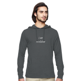 A man wearing a dark gray heathered pullover hoodie with the text 'i am revolution' printed in white script on the chest, shown against a plain white background.