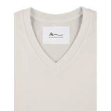 Details view of women's off white short sleeve V-neck affirmation T-shirt, Behave Beautifully series by Le Van Kamp Studio